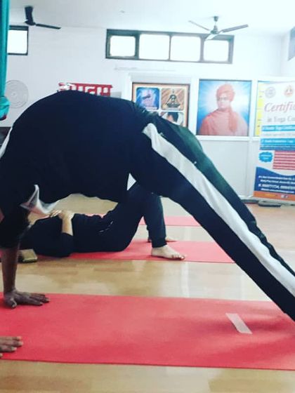 A powerful demonstration of Camatkarasana (Wild Thing). This pose is an exhilarating backbend that opens the heart and builds strength, combining the elements of a lunge and a backbend.