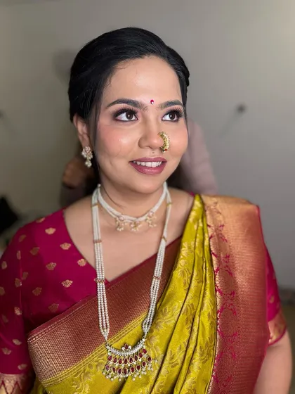 A side profile showcasing the soft eye makeup and the elegant braided hairstyle.