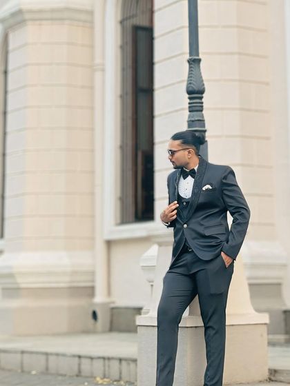 A stylish pose in a classic three-piece suit. This is a great look for a pre-wedding shoot or a reception party.