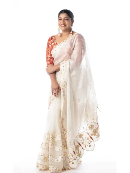 The final look for Aparna Balamurali. The white organza saree is draped to create a look of ethereal elegance.