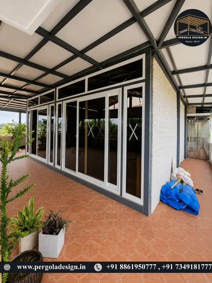 For larger terraces, we provide robust and practical solutions. This image shows a spacious enclosure using puff sheet roofing for insulation and a full-length sliding glass system, creating a versatile, semi-enclosed area.
