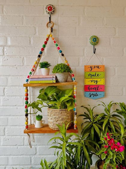 We love working with colorful wooden beads, and these beaded double shelves are a great example of that. Paired with a 'You Make My Heart Smile' wooden hanging, this setup is sure to bring joy to any space.