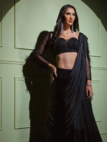 A full shot of the black feather-sleeve drape saree, a perfect blend of classic elegance and modern couture.