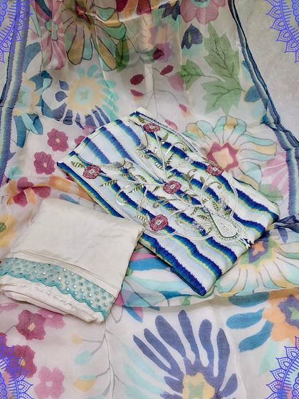 This beautiful unstitched suit set features a striped top with delicate floral embroidery. The organza dupatta has a lovely digital floral print, creating a fresh and modern look.