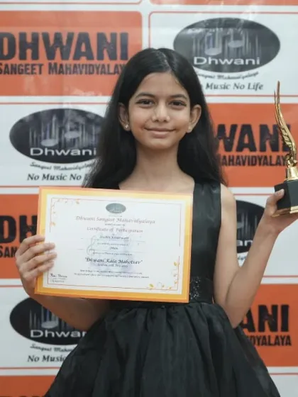 A young artist elegantly poses with her certificate and award.