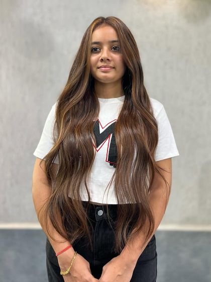 The front view of this Air Touch balayage shows how the technique can be used to frame the face with lighter pieces, creating a sun-kissed glow.