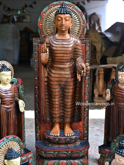 A 36-inch standing Buddha statue, hand-painted with an antique finish. The blessing gesture and serene stance make it a commanding piece.