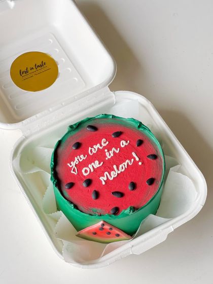 A playful and punny "you are one in a melon!" bento cake, designed to look just like a slice of watermelon.
