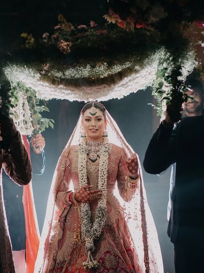 Radhika's dramatic bridal entry under a 'phoolon ki chadar'. The spotlight effect creates a heavenly glow, making this a truly magical and cinematic moment.