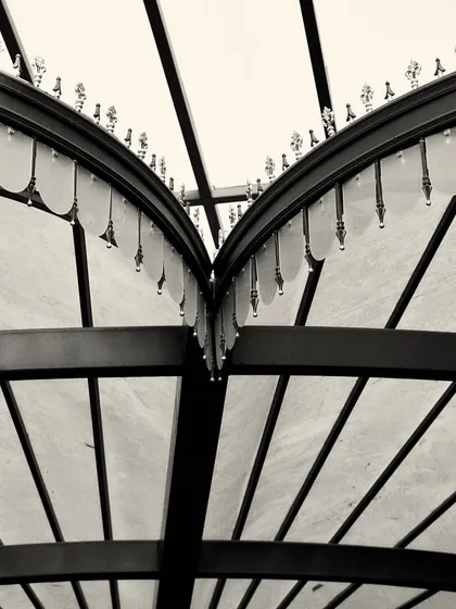 A detailed close-up of the decorative metalwork and glass fringe on the custom light fixtures, showcasing the level of craftsmanship involved.