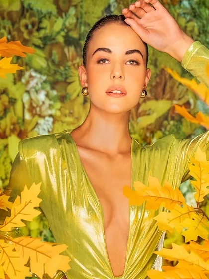 A vibrant, autumnal scene with falling leaves, crafted through projection. This method allows me to create a seasonal atmosphere that complements the colors and textures of the fashion.
