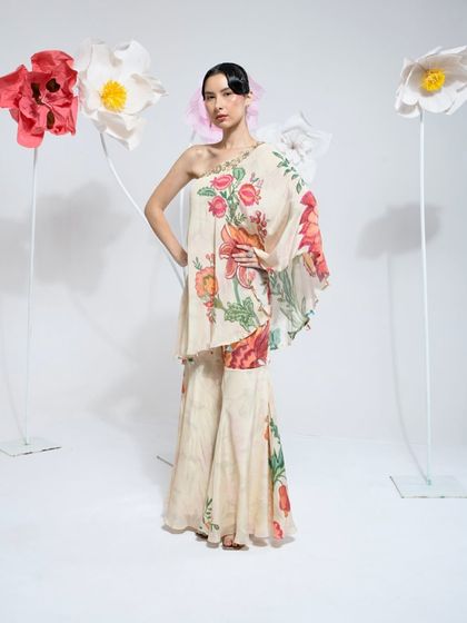 This extensive collection features a wide array of modern festive attire. From vibrant sharara sets and elegant anarkalis to chic jumpsuits and light lehengas, these pieces are curated for wedding guests and anyone looking for a stylish outfit for a special occasion.