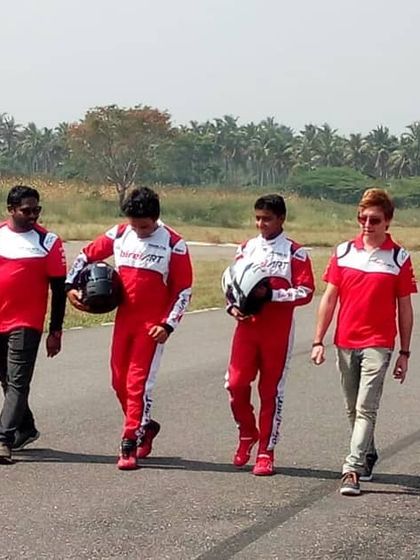 The Birel ART India team walking the track, a classic image of camaraderie and focus during a Formula LGB training day.