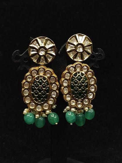 These elegant earrings with green enamel and bead drops are a versatile rental option for any festive occasion.