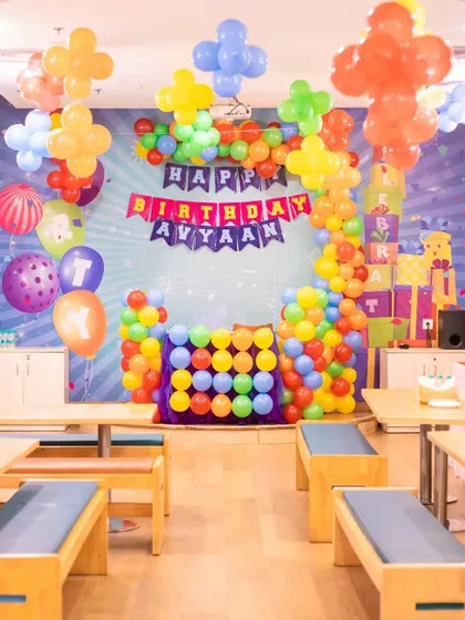 A colorful, block-themed party setup. The vibrant balloon arch and matching decor create a playful and festive atmosphere right from the entrance.