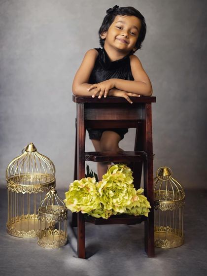 A sweet and relaxed pose from a toddler. We use simple props like this stool to create classic and timeless children's portraits.