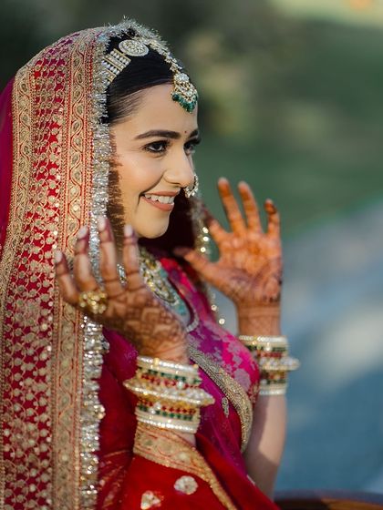 A candid, joyful moment. The bride's smile is infectious, and her minimal makeup lets her happiness be the main focus.