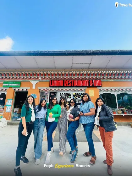 A glimpse of our ongoing trip in Bhutan. A group of women poses in front of a local restaurant, showcasing the fun, food, and friendships we explore in the Himalayan kingdom.