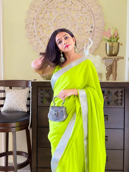 A candid moment, feeling the joy of wearing something made with so much love. That's the real story behind this saree.