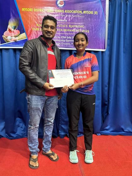 Rashi V Rao receives her certificate for the Under 15 Girls singles Runner-Up position at the Mysore State Ranking Tournament.