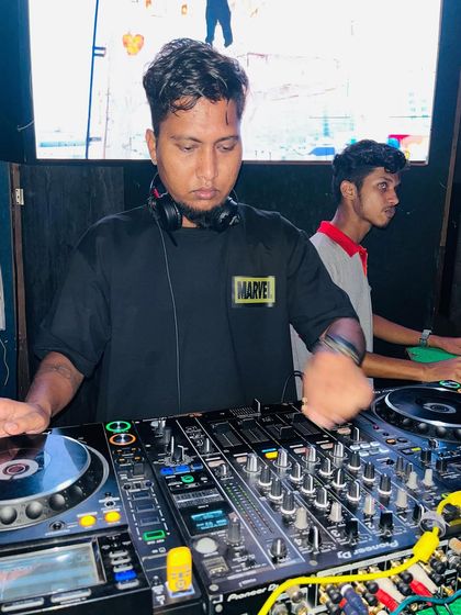 In the zone, focused on the mixer. Every event gets my full attention to detail to ensure the music is perfect.