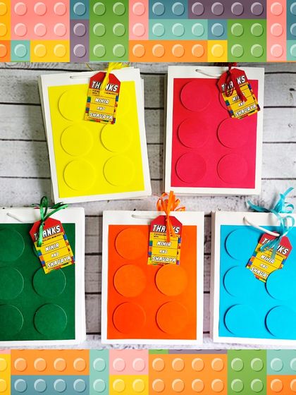 The handmade paper bags for the building block theme are one of my specialties. They come in bright colors with 3D dots to look like giant bricks.