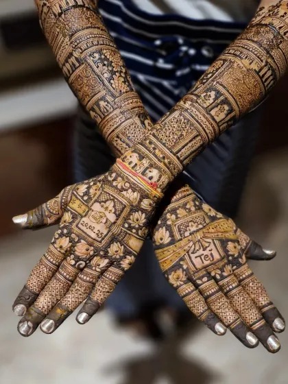 A different angle of the personalized traditional mehendi, showing how the date and name are seamlessly integrated with classic floral and elephant motifs.