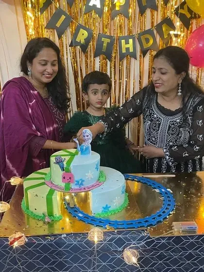 A fun fusion cake for a child who loves both Frozen and Cocomelon. The cake is split into two themes and includes a toy train track.