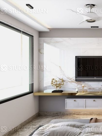 A minimalist TV setup with a floating shelf, set against a clean, white marble wall.