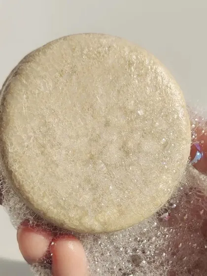 A close up of the lather from our Moringa shampoo bar, shared by a happy customer. They note that it effectively rebalances scalp moisture and leaves hair soft and flake free from the very first wash.