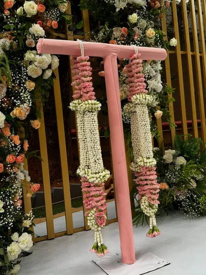 A detailed look at the hand-strung Varmala garlands, made with jasmine and pink flowers, ready for the couple's exchange ceremony.