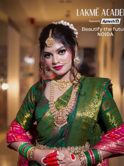 A full-length portrait of a bride in a classic green and pink saree. This look, often seen in Maharashtrian or South Indian weddings, showcases our versatility in regional styles.