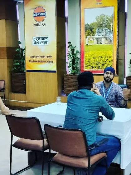 Engaging with employees during a consultation at an IOCL event. Creating a comfortable space for people to share their health challenges is key.