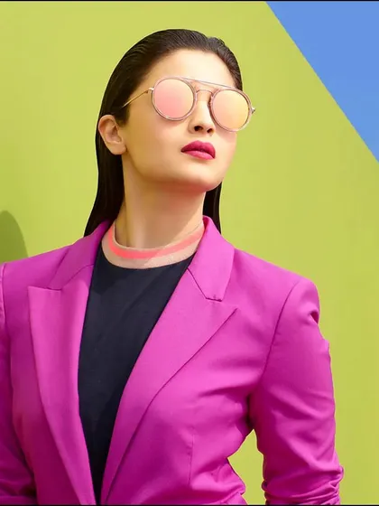 Fashion is a playground of color and form. In this campaign shoot with Alia Bhatt, we used bold, contrasting colors to create a vibrant and modern look. The slicked-back hair and sharp styling give the portrait a high-fashion, graphic quality that really stands out.