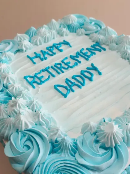 A lovely square cake to celebrate a dad's retirement, with blue and white buttercream rosettes.
