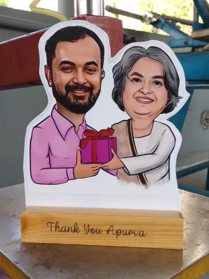 My caricature cut-outs are one of my most popular gifts. I turn a digital drawing into a physical statue with a custom message on a wooden base, perfect for farewells or as a thank you gift.