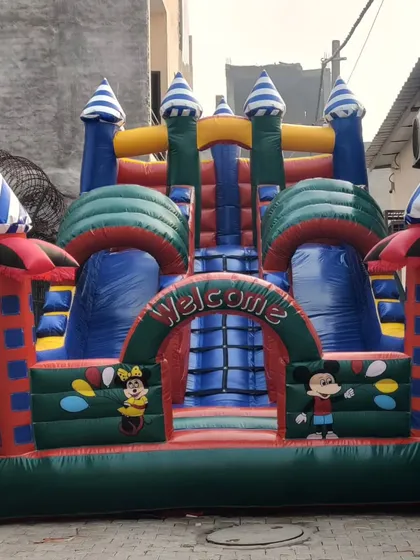 A classic castle design featuring Mickey and Minnie Mouse. The striped turrets and "Welcome" arch make it an inviting attraction for younger children.
