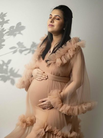 Soaking in the moment. This artistic solo portrait uses the soft shadow of leaves to add a unique and natural element to the image.