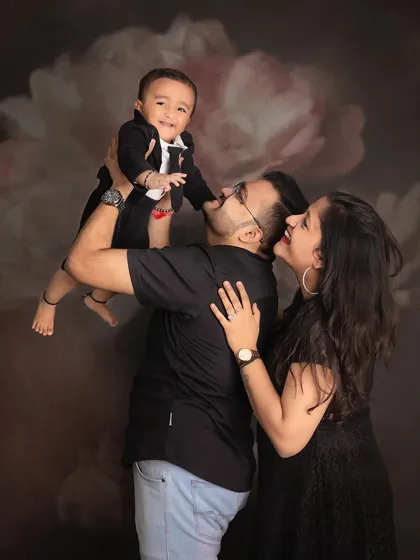 Twinkle, twinkle, little star. This candid family photo captures a sweet, playful moment between parents and their little boy, full of adoration and joy.