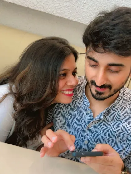 A candid moment of us looking at a phone together. It's the simple, everyday interactions that build a strong partnership.