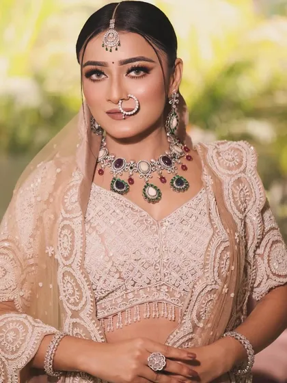 A full view of this contemporary bridal look. The intricately embroidered off white lehenga is perfectly complemented by the soft, neutral makeup palette.