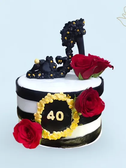 A glamorous cake for a fashionista turning 40. This design features a stylish black high heel, red roses, and a chic black and white striped pattern.