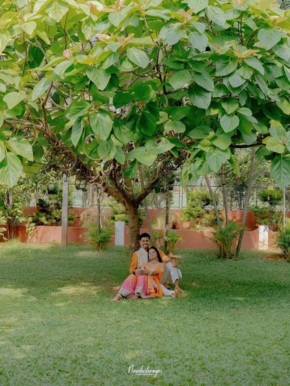 A peaceful moment for the couple under the shade of a large tree. This romantic portrait offers a quiet contrast to the energetic Haldi festivities.