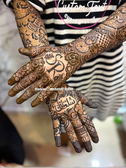 A close-up of the palms, showing the initial 'R' and the name 'Sultana' in Arabic script.