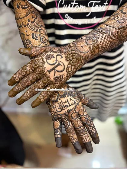 A close-up of the palms, showing the initial 'R' and the name 'Sultana' in Arabic script.