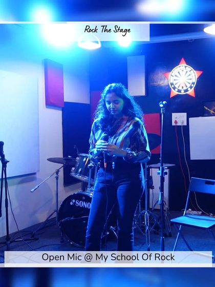 A poet lost in her words under the stage lights. This shot captures the focus and emotion that performers bring to our open mic.