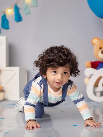 Taking my first little steps into a whole new year! A cute moment from a first birthday shoot with a blue and teddy bear theme.