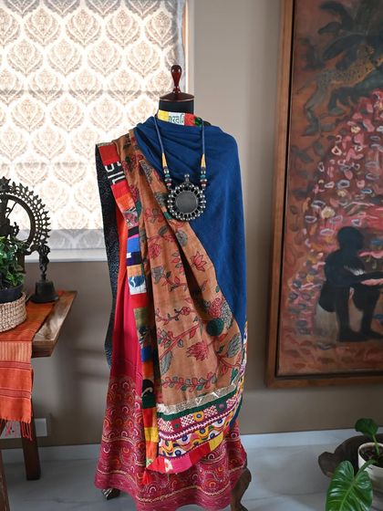 The reverse side of the shawl, showing how the solid blue Kala cotton provides a calming backdrop to the intricate Kalamkari panel. This piece offers two distinct looks in one.