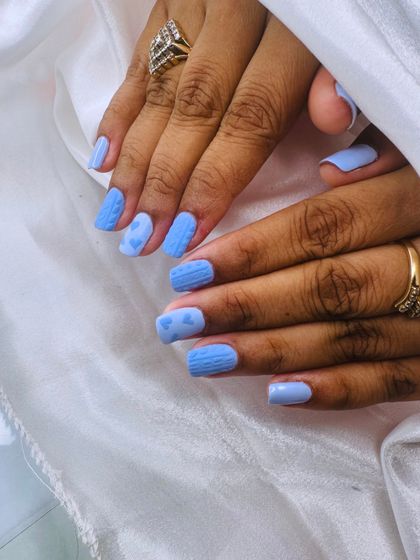 Another look at the charming sweater nail art, showing the combination of cable-knit texture and tiny hearts.