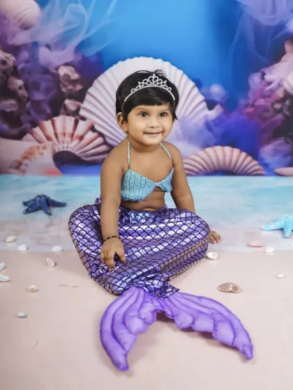 Let's dive into a fantasy world with a magical mermaid photoshoot. I provide the complete costume and underwater-themed backdrop to bring your little one's fairy tale dreams to life.